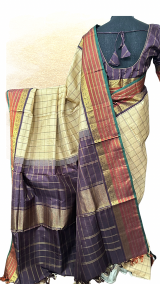 Traditional Ven Pattu Kanjivaram saree with rich golden zari checks and embroidered stitched blouse.
