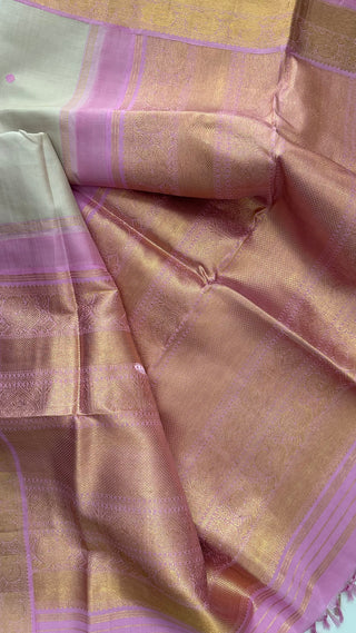 Traditional Kanjivaram Ven Pattu saree featuring pastel pink body, shimmering silver zari, and a premium stitched blouse for Indian bridal wear.