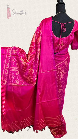 Bright pink Patola silk saree showcasing intricate handloom craftsmanship and classic border design.