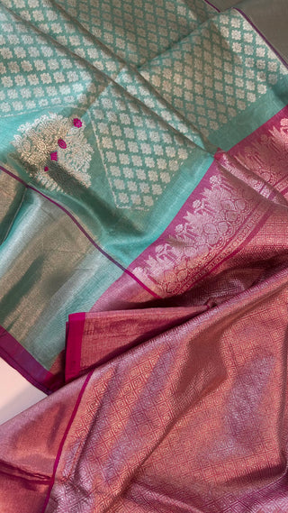 Traditional turquoise green silk saree with contrast blouse and fine zari work