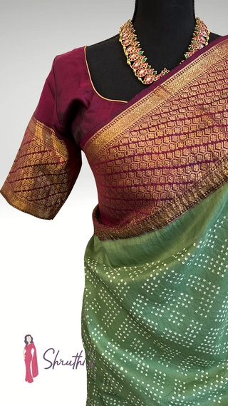 Elegant green silk saree with maroon zari border for weddings.