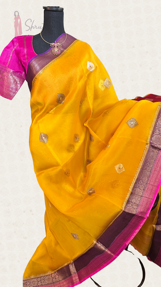 Elegant yellow and pink Banaras organza silk saree with gold zari border and ready-to-wear stitched blouse, perfect for festive occasions.