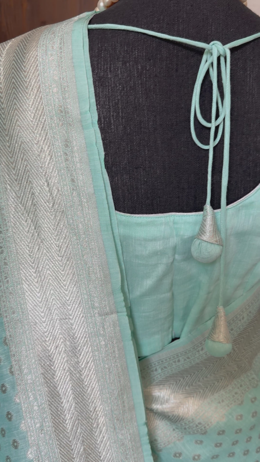 Soft pastel cyan linen saree with silver zari detailing and easy drape