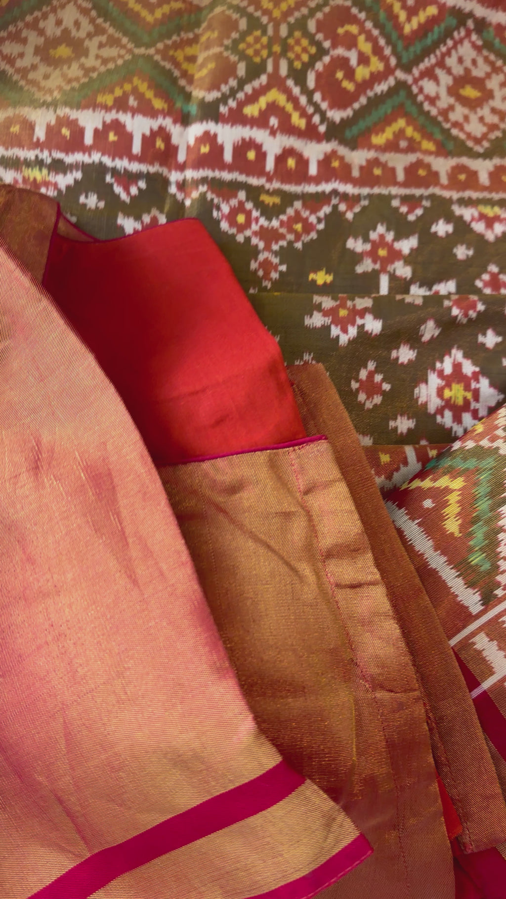 High-quality tissue Patola silk saree showcasing intricate ikat motifs, gold zari woven pallu, and elegant border, designed for grand occasions.