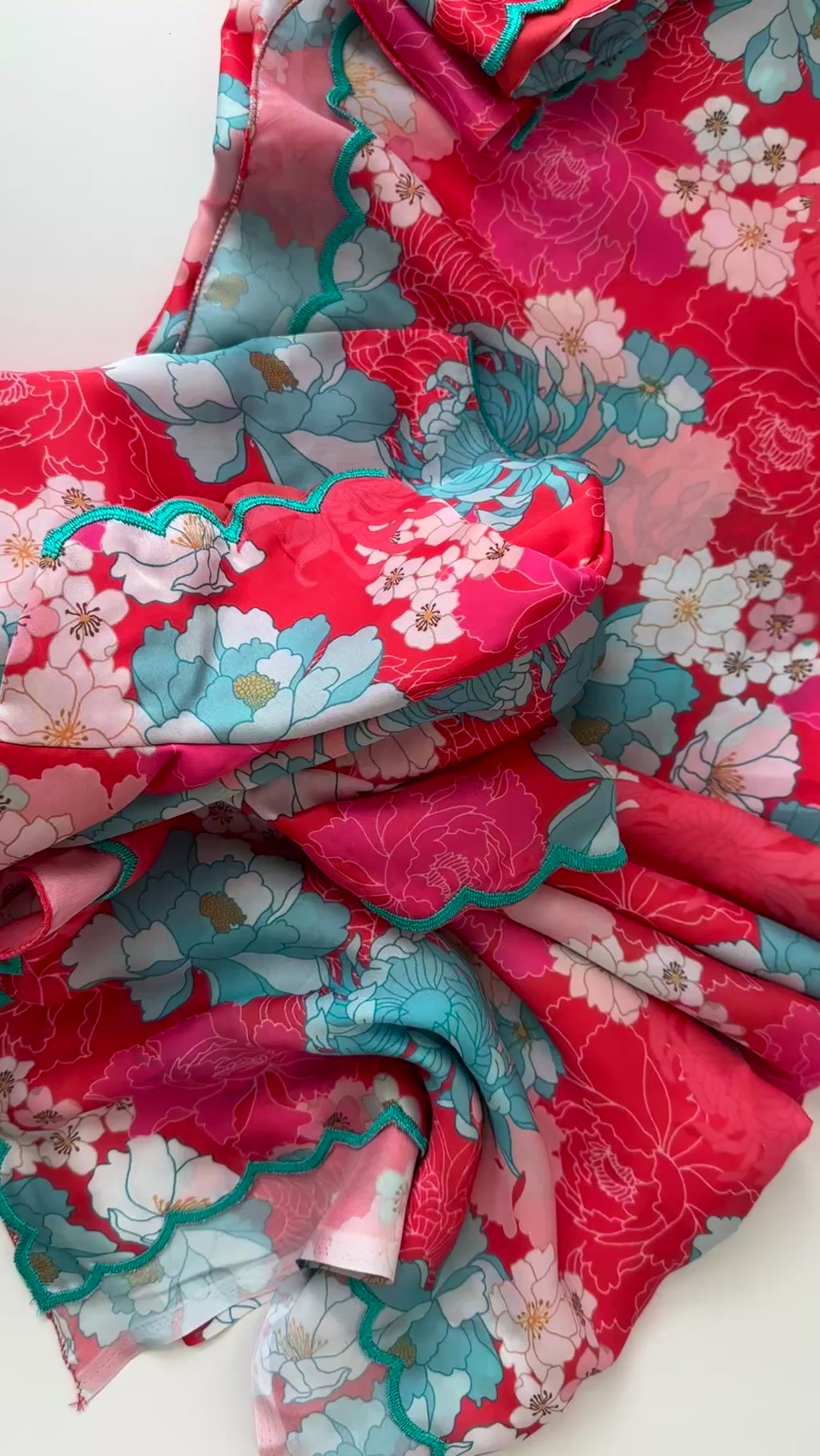 Elegant floral satin silk saree in pink with long-sleeve stitched blouse and easy-drape satin fabric.