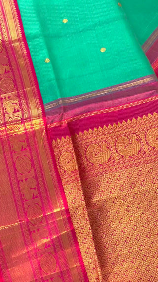 Pure Kanjivaram pink double-shaded saree gently draped on mannequin, showing soft silk texture and elegant fall, ideal for brides.