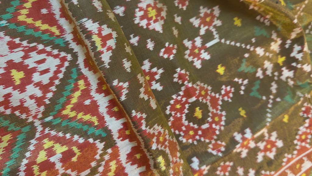 Premium white Patola saree crafted with fine silk threads, showcasing traditional patterns and paired with embroidered ready blouse.