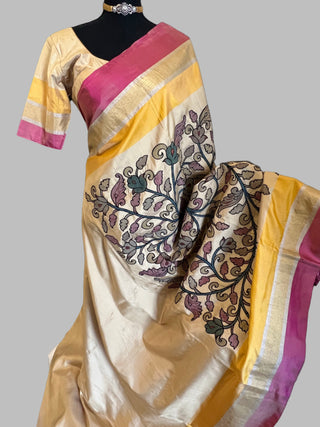 A pure soft silk saree with Kalamkari applique work, featuring a beige color with floral embroidery and a yellow border.